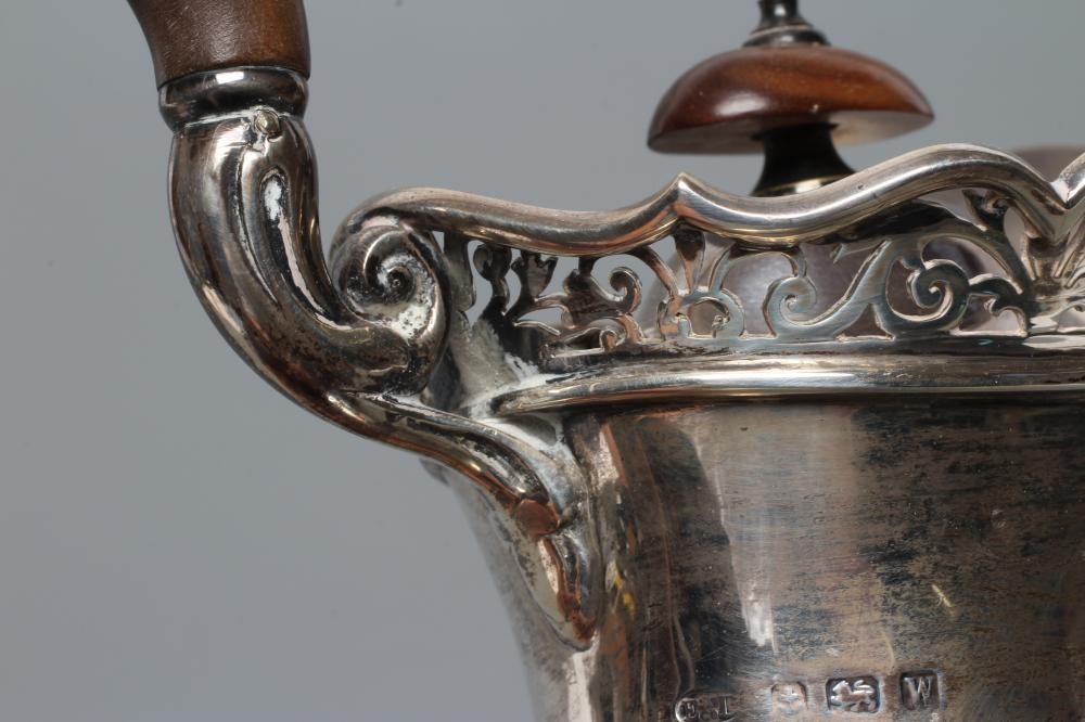 A SILVER COFFEE POT Image