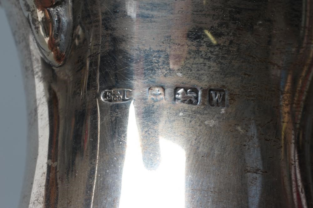 A SILVER COFFEE POT Image