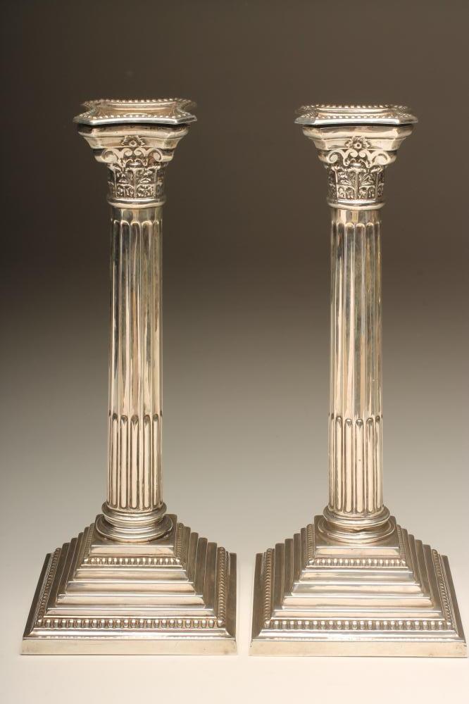 A PAIR OF SILVER CORINTHIAN COLUMN CANDLESTICKS Image