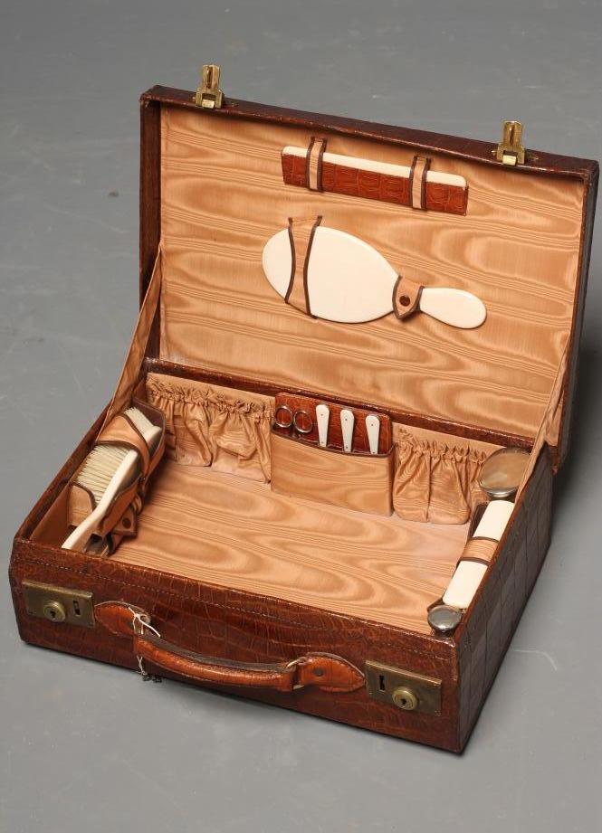 A CROCODILE SKIN TRAVELLING DRESSING CASE Image