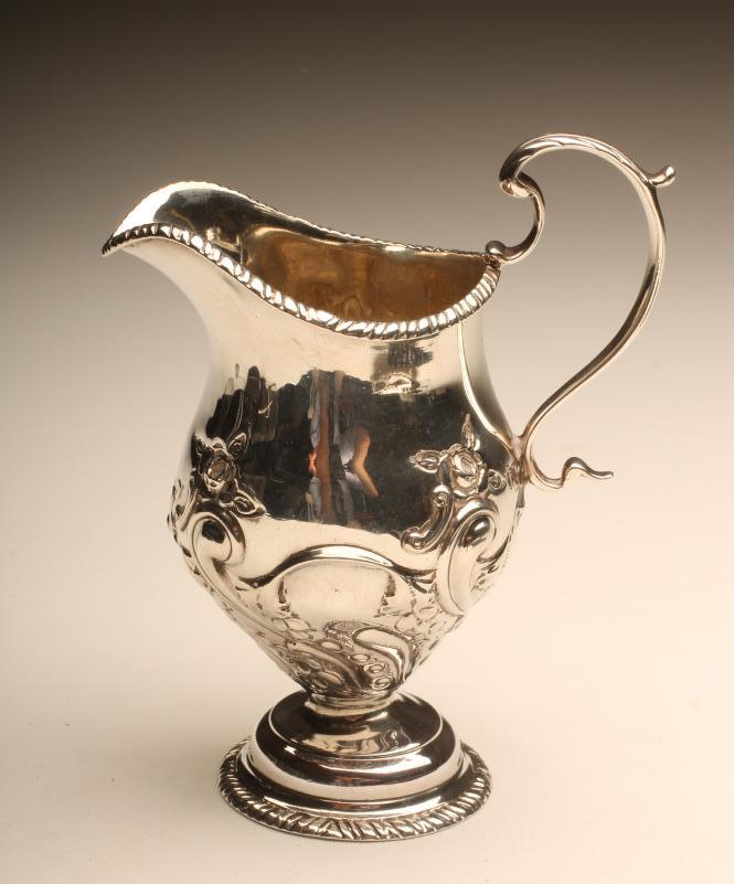 A LATE VICTORIAN SILVER MILK JUG Image
