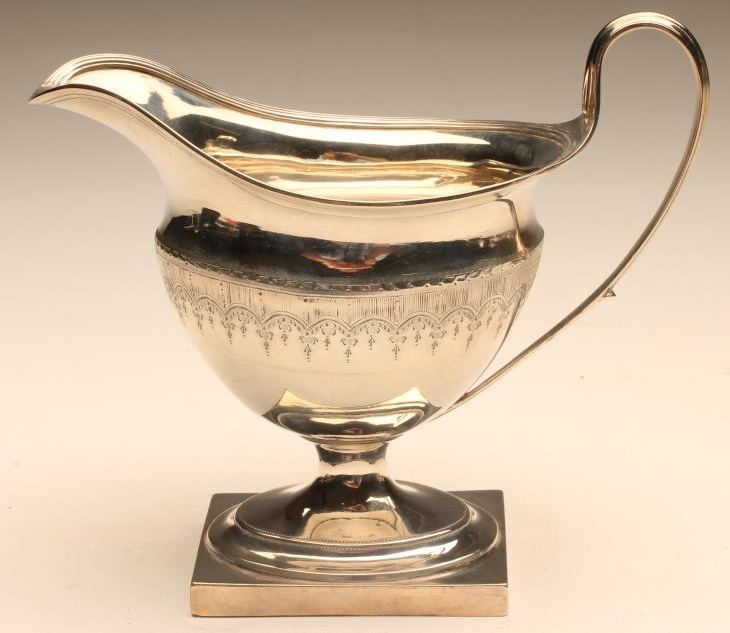 A GEORGE III SILVER MILK JUG Image