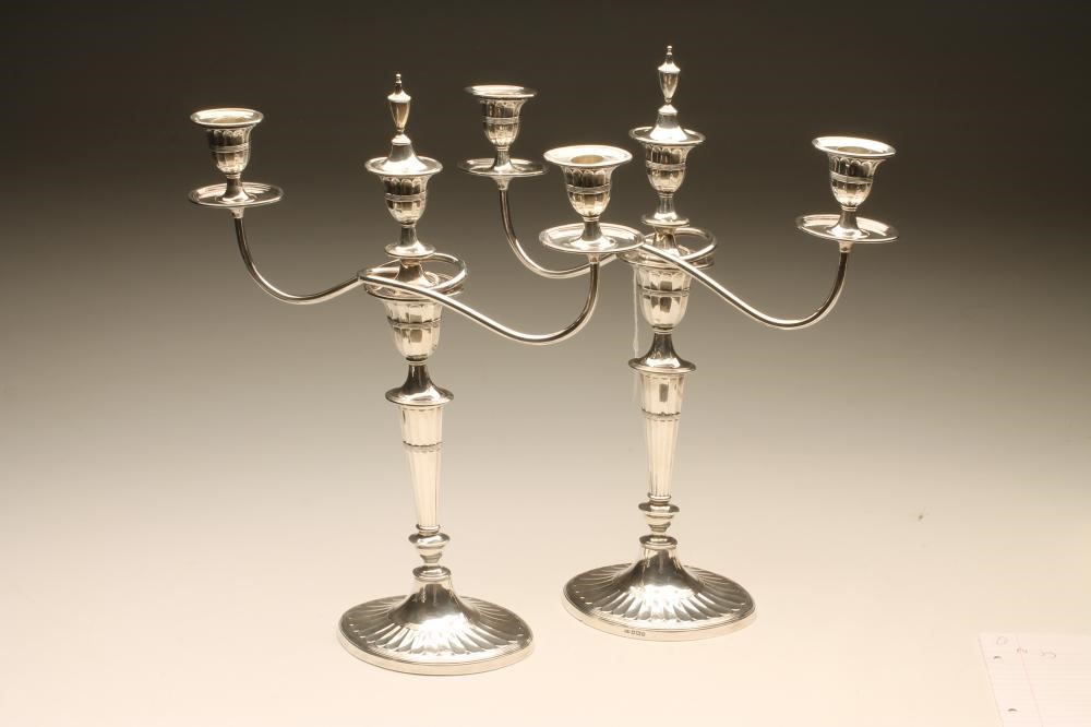 AN EDWARDIAN SILVER PAIR OF TWO BRANCH THREE LIGHT CANDELABRA Image