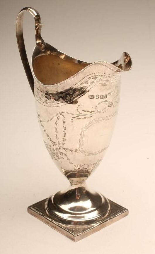 A GEORGE III SILVER MILK JUG Image
