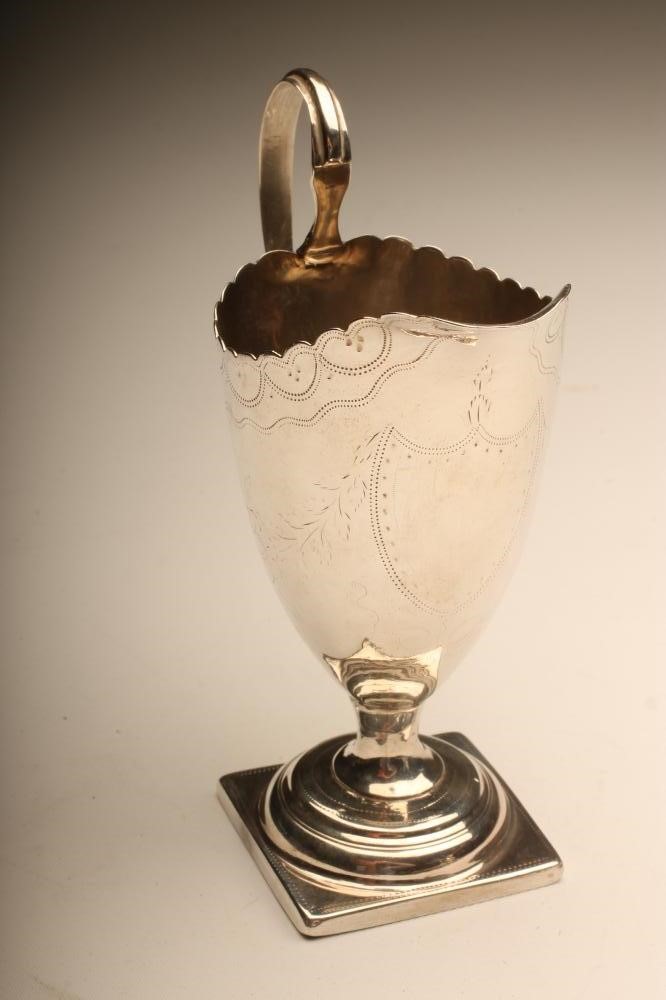 A GEORGE III SILVER MILK JUG Image