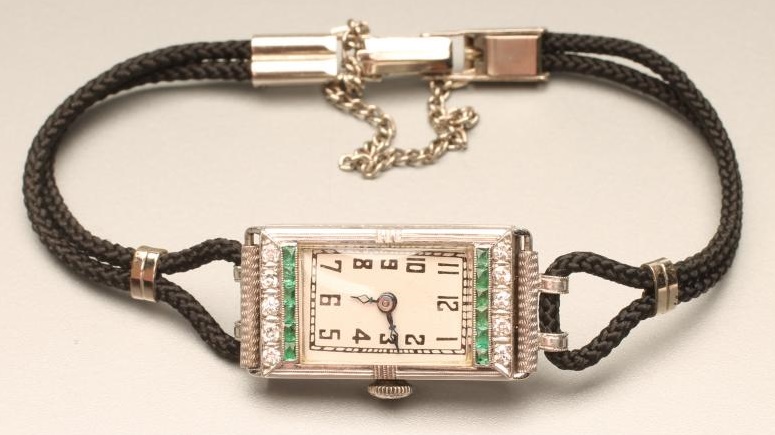 AN ART DECO DIAMOND AND EMERALD COCKTAIL WATCH Image