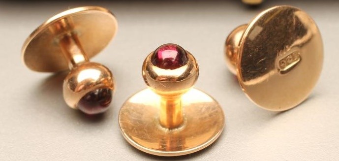 A SET OF THREE 9CT GOLD SHIRT STUDS each set with a cabochon polished ruby Image