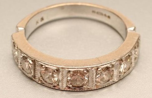 A SEVEN STONE DIAMOND HALF HOOP RING Image
