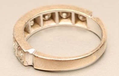 A SEVEN STONE DIAMOND HALF HOOP RING Image