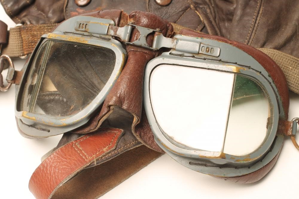 A PAIR OF BRITISH FLIGHT GOGGLES with painted brass frames and leather padding Image