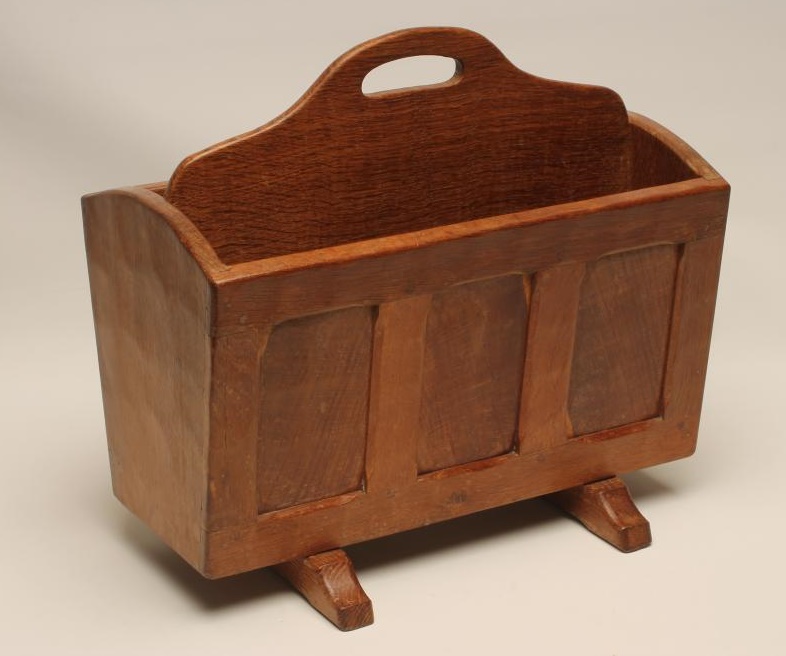 AN ADZED OAK MAGAZINE RACK in the manner of Robert Thompson Image