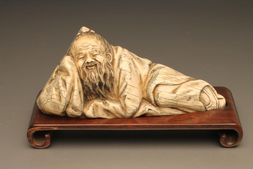 A CHINESE IVORY FIGURE carved as sleeping bearded men Image