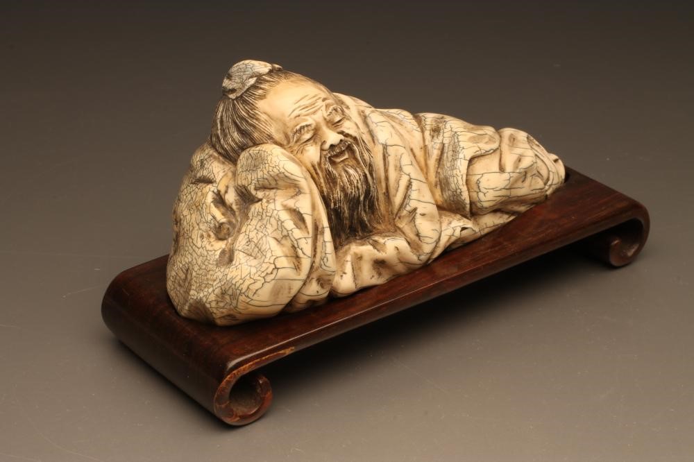 A CHINESE IVORY FIGURE carved as sleeping bearded men Image