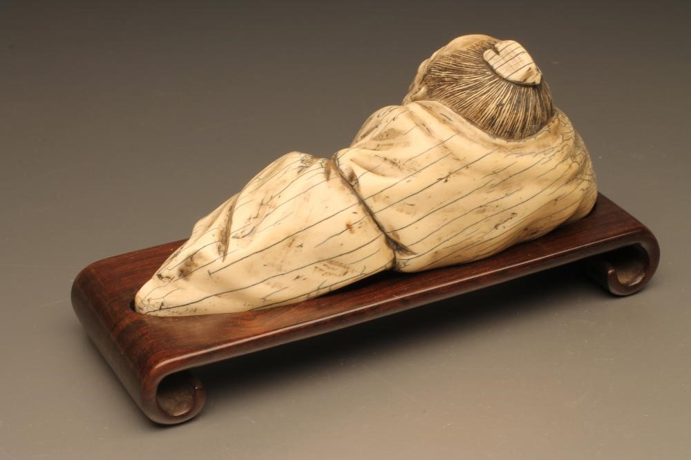 A CHINESE IVORY FIGURE carved as sleeping bearded men Image