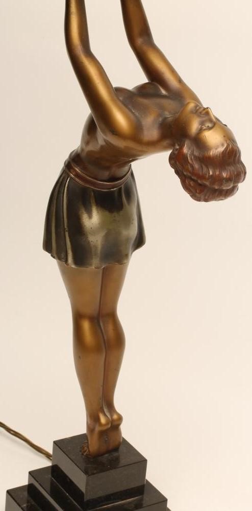 AN ART DECO BRONZED SPELTER FIGURAL LAMP BASE modelled as a young woman Image