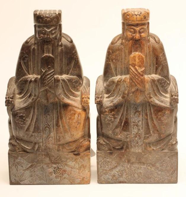 A PAIR OF CHINESE SOAPSTONE FIGURES carved as bearded dignitaries seated on a throne and holding a Image