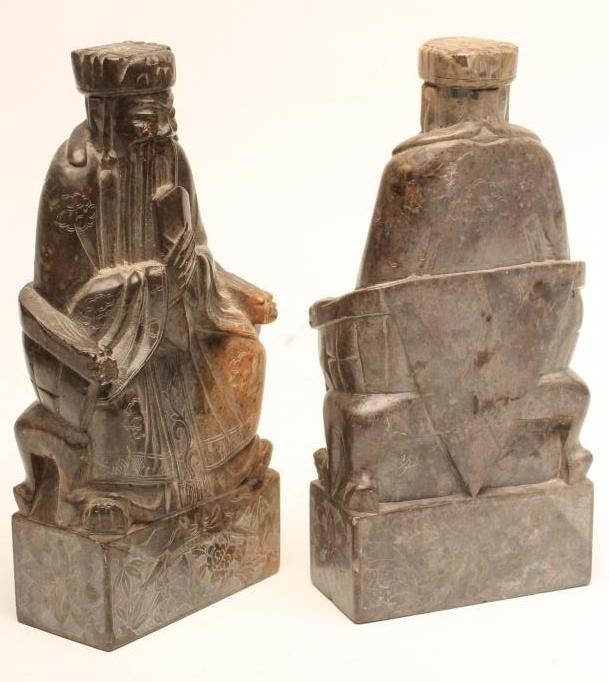 A PAIR OF CHINESE SOAPSTONE FIGURES carved as bearded dignitaries seated on a throne and holding a Image