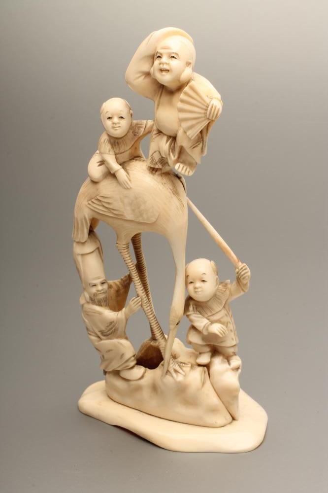 A JAPANESE IVORY FIGURE GROUP Image