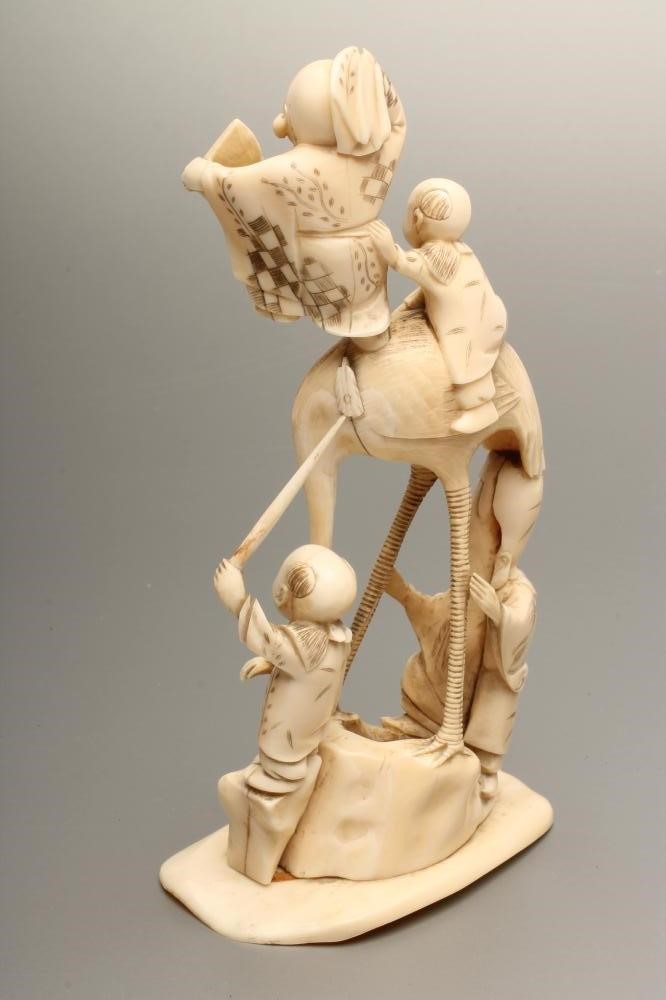A JAPANESE IVORY FIGURE GROUP Image