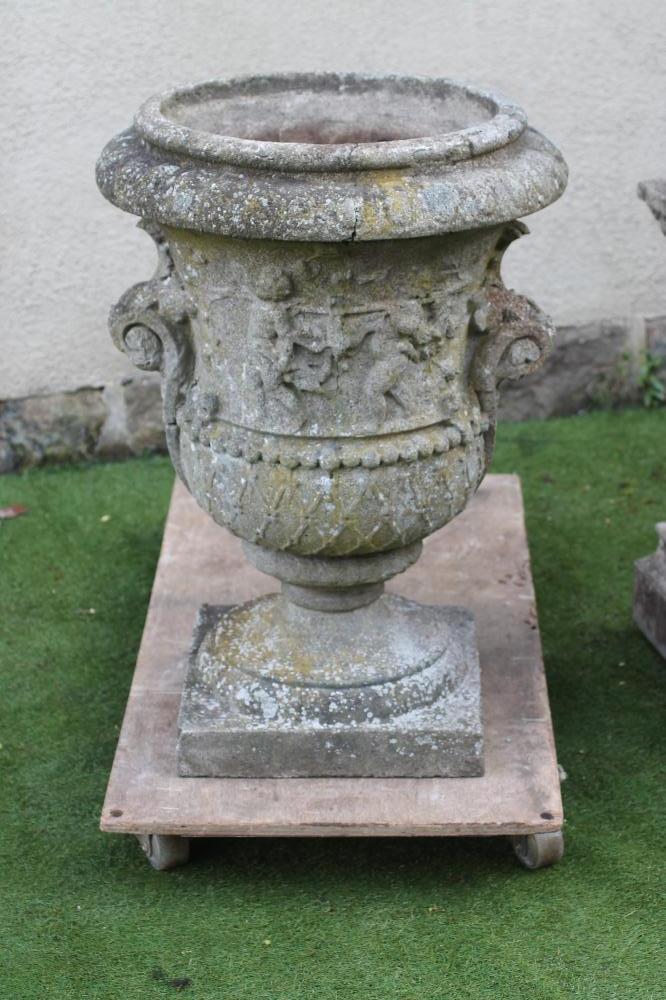 A LARGE COMPOSITION STONE URN of waisted form with scrolled handles Image