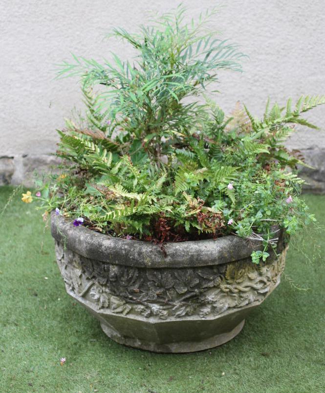 A COMPOSITION STONE PLANTER of faceted circular form Image