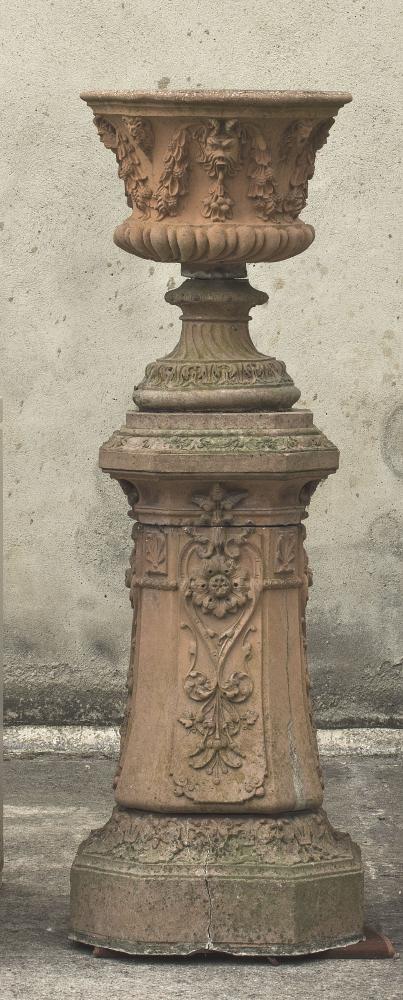 A TERRACOTTA URN ON STAND Image