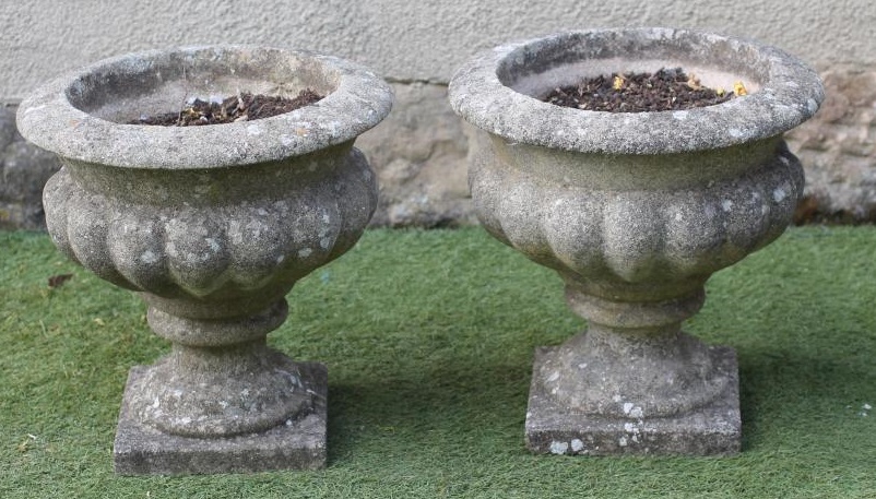A PAIR OF COMPOSITION STONE URNS Image