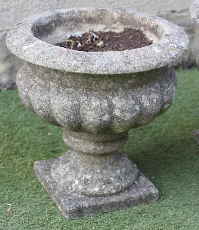 A PAIR OF COMPOSITION STONE URNS Image
