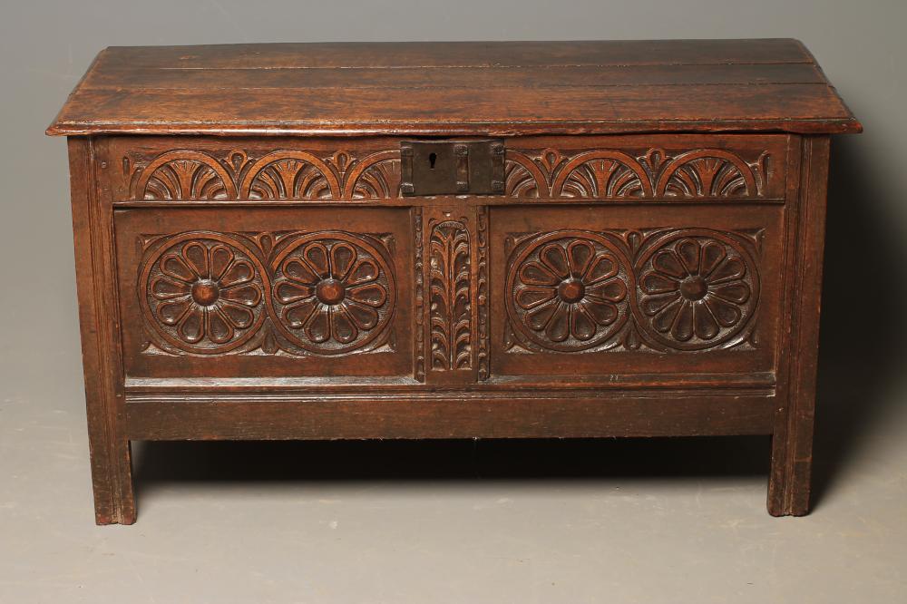A CARVED OAK PANELLED COFFER Image