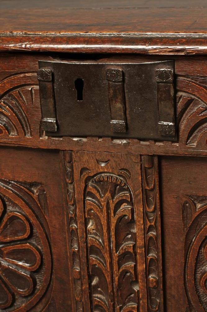 A CARVED OAK PANELLED COFFER Image