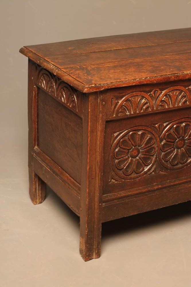 A CARVED OAK PANELLED COFFER Image