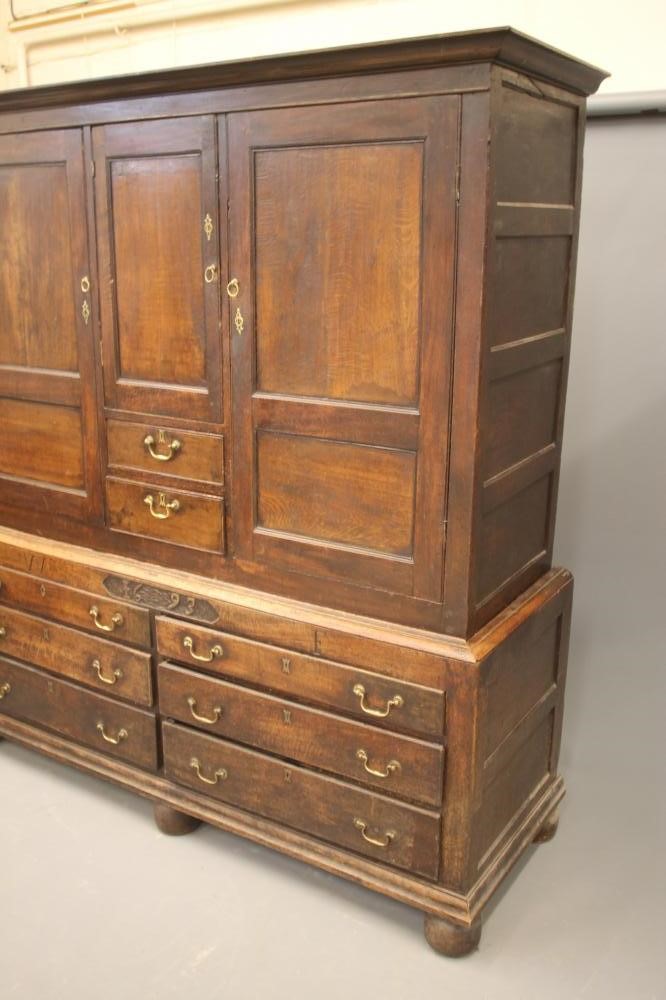 AN EARLY GEORGIAN JOINED OAK PRESS CUPBOARD Image