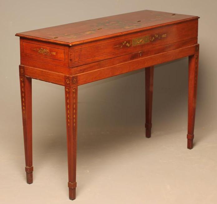 A LADY'S MAHOGANY DESK of oblong form painted with floral swags and musical trophies and with Image