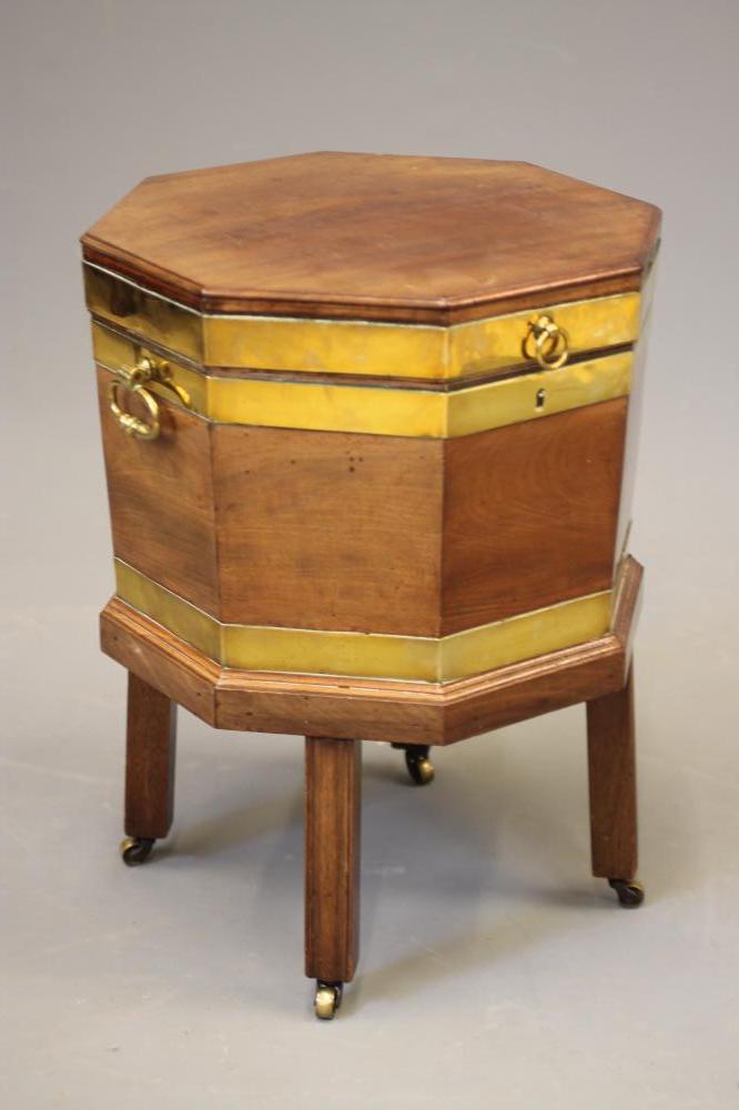 A GEORGIAN MAHOGANY AND BRASS BOUND CELLARETTE of octagonal form Image