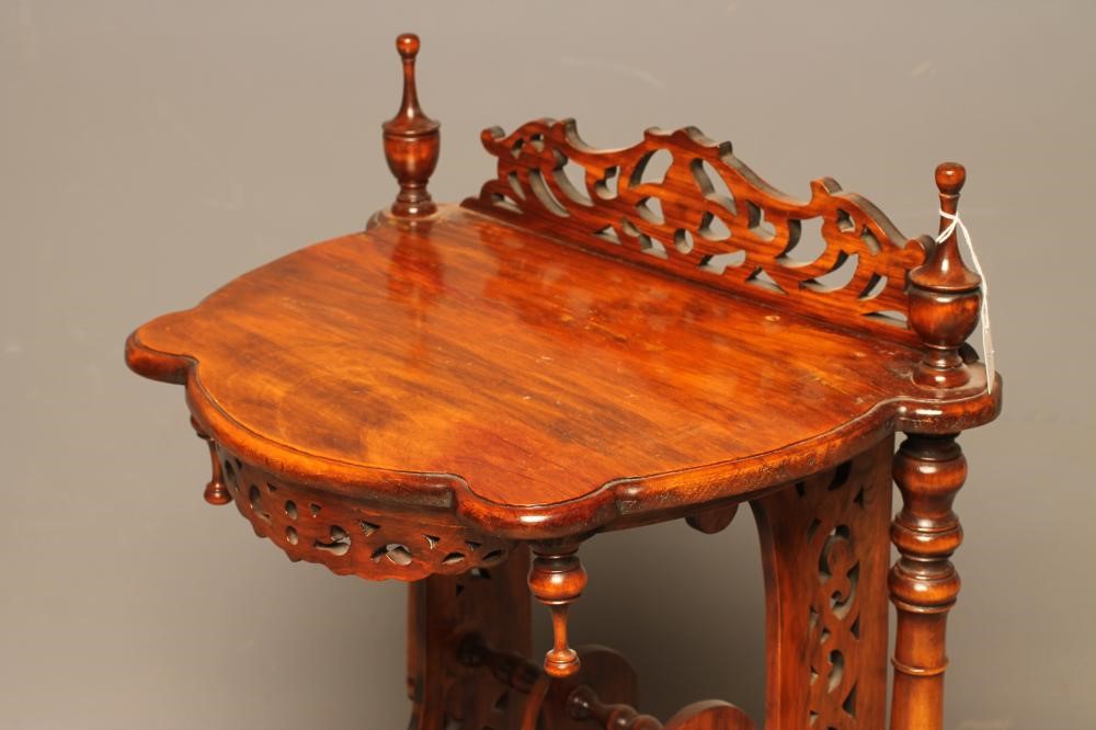 A VICTORIAN WALNUT CANTERBURY of shaped D form Image