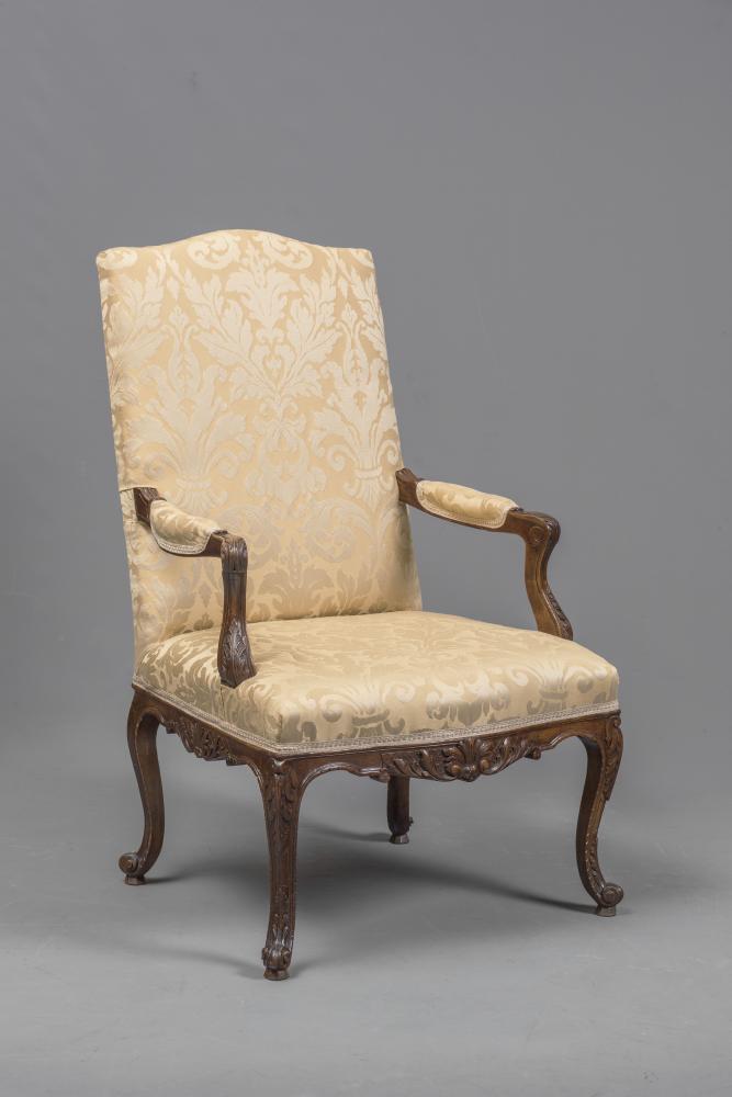A FRENCH CARVED WALNUT ARMCHAIR Image