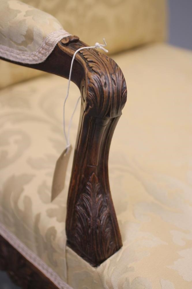 A FRENCH CARVED WALNUT ARMCHAIR Image
