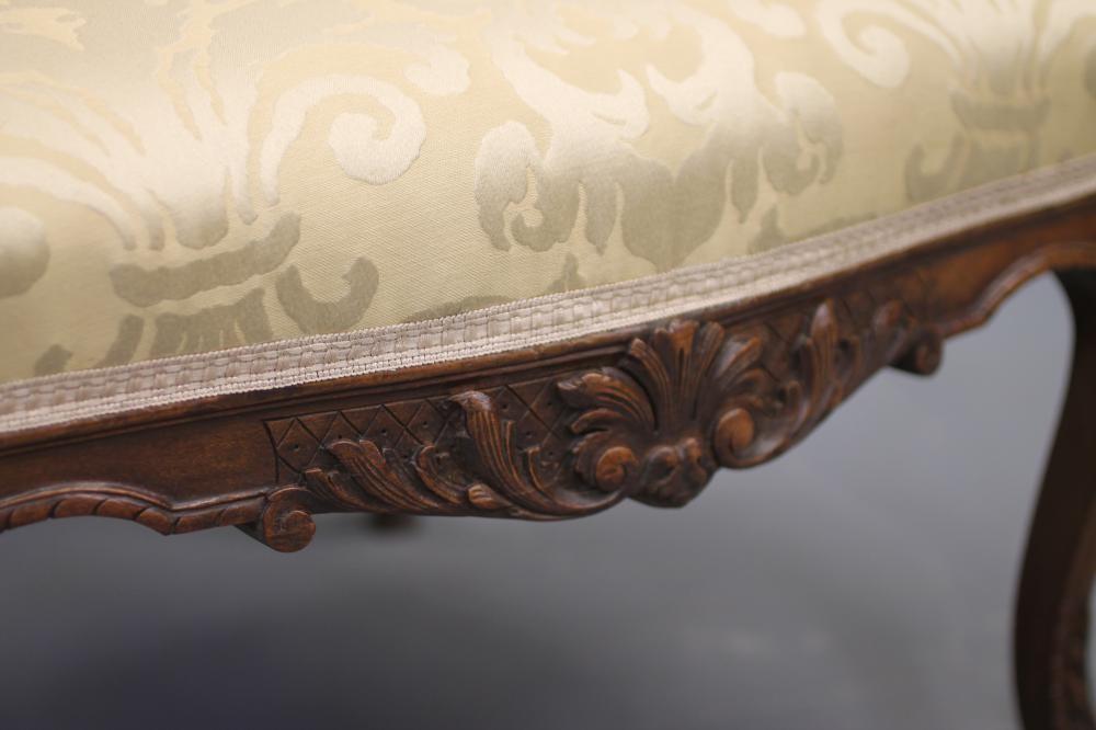 A FRENCH CARVED WALNUT ARMCHAIR Image