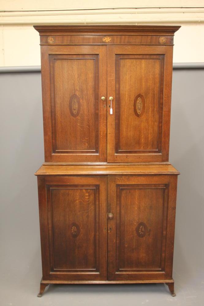 A GEORGIAN OAK TWO STAGE CUPBOARD Image