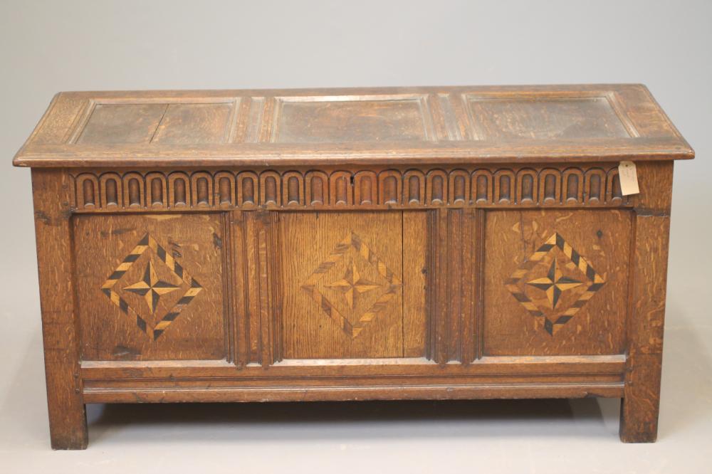 AN OAK PANELLED COFFER Image