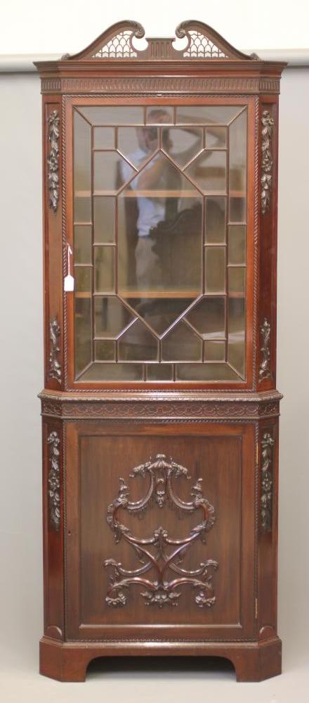 AN EDWARDIAN MAHOGANY STANDING CORNER CUPBOARD in the Georgian rococo style Image