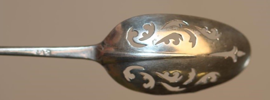 A GEORGE II SILVER MOTE SPOON Image