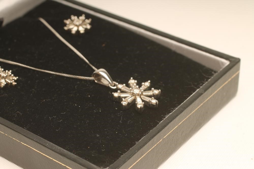A DIAMOND PENDANT AND MATCHING EAR STUDS Image