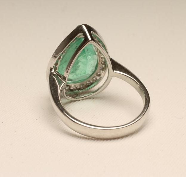 AN EMERALD AND DIAMOND COCKTAIL RING Image