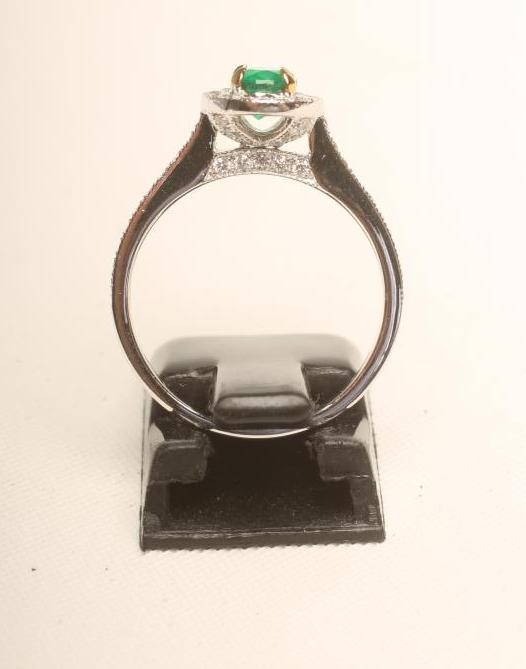 AN EMERALD AND DIAMOND CLUSTER RING Image
