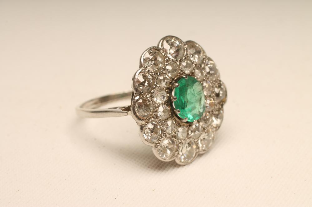 AN EMERALD AND DIAMOND FLOWERHEAD RING Image