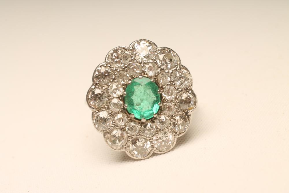 AN EMERALD AND DIAMOND FLOWERHEAD RING Image