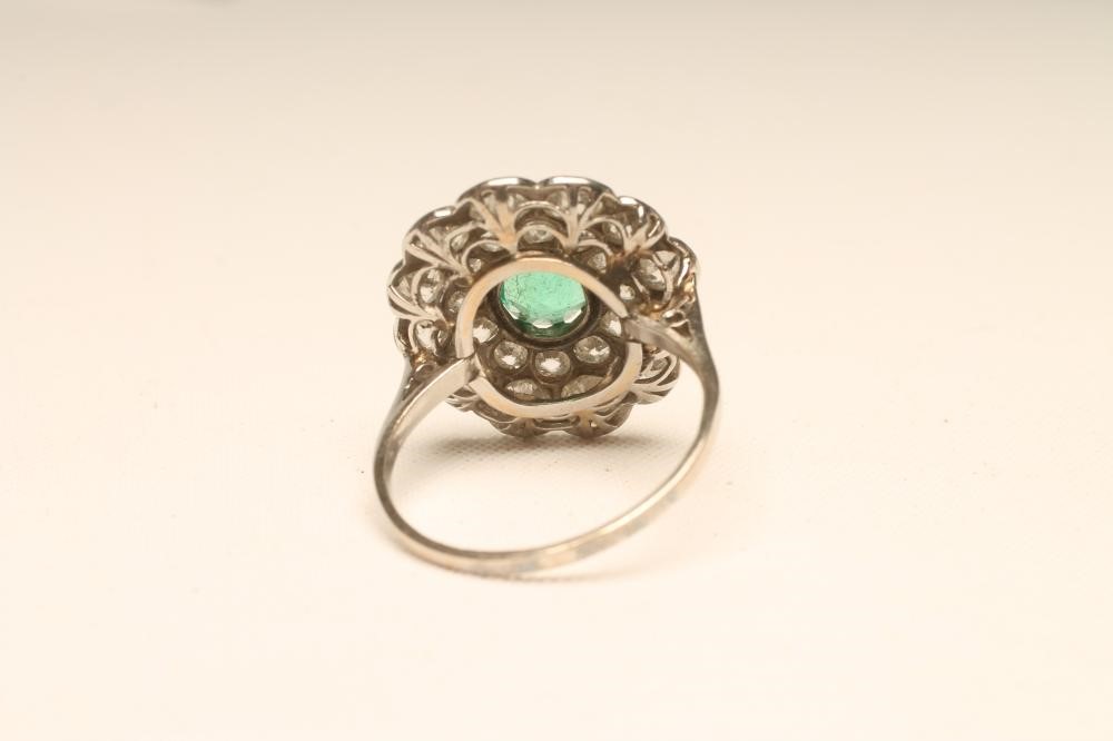 AN EMERALD AND DIAMOND FLOWERHEAD RING Image