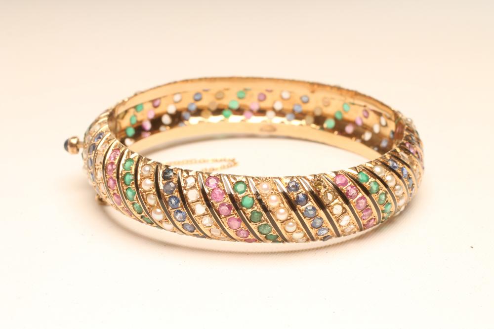 A MULTI-GEM SET STIFFED HINGED BANGLE Image