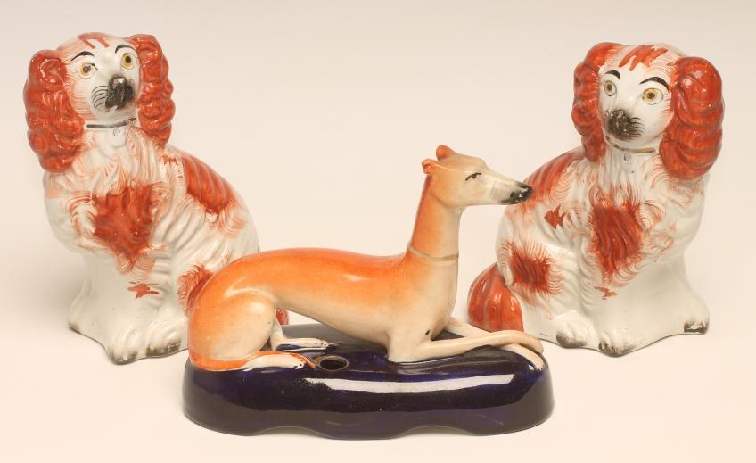 A SMALL PAIR OF VICTORIAN STAFFORDSHIRE POTTERY SPANIELS Image
